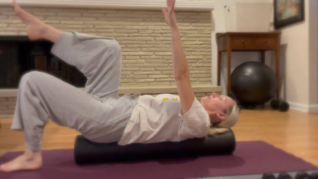 Woman balancing on foam roller