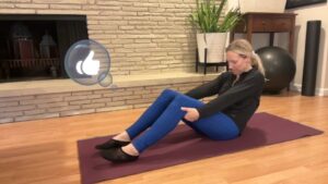 woman doing pilates on the mat rolling back