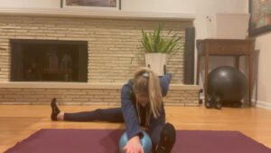 woman doing pilates stretching on mat